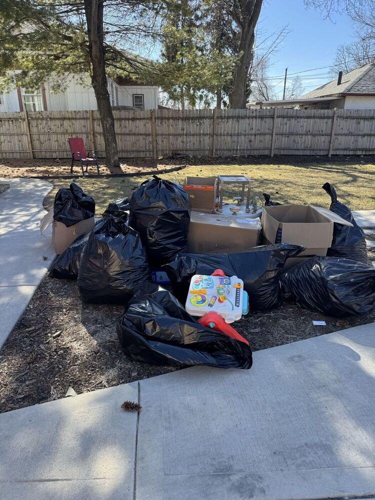 Bagged junk and boxes at the curb before 708 JUNK curbside pickup